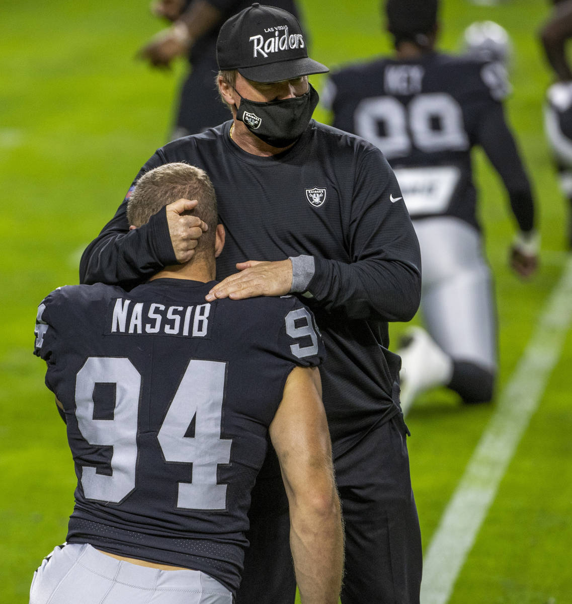 Las Vegas Raiders head coach Jon Gruden greets defensive end Carl Nassib (94) before the start ...