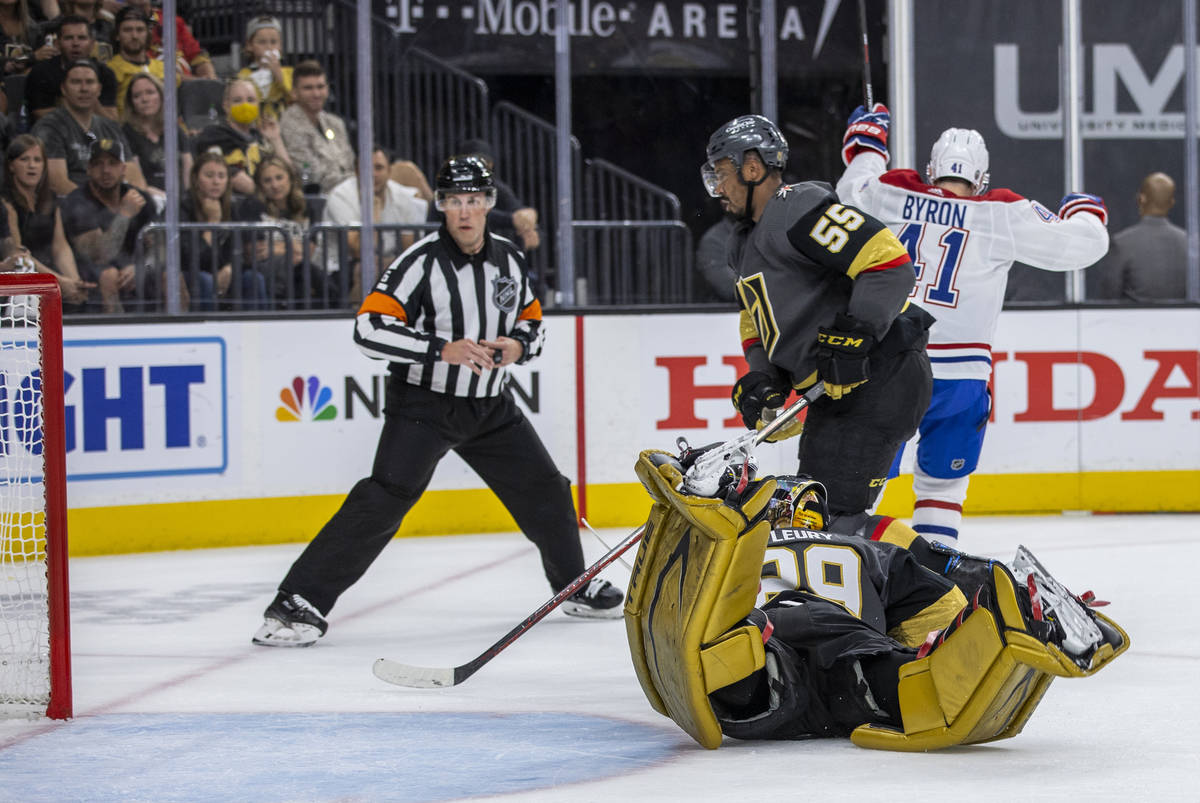 A referee looks to the net as Golden Knights goaltender Marc-Andre Fleury (29) dives but misses ...