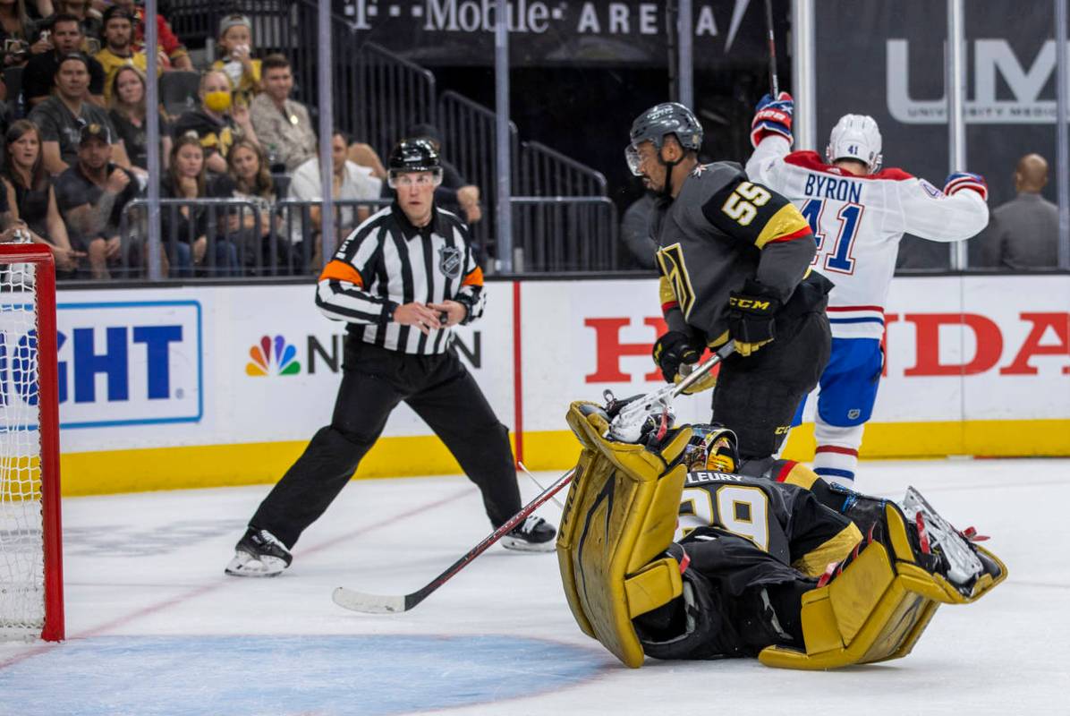 A referee looks to the net as Golden Knights goaltender Marc-Andre Fleury (29) dives but misses ...