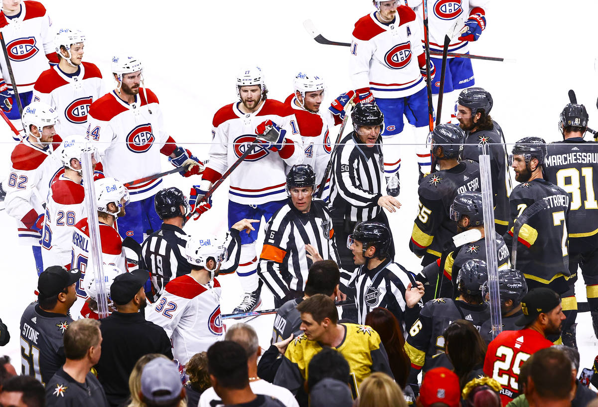 Referees try to keep the Montreal Canadiens from the Golden Knights after the Habs defeated the ...