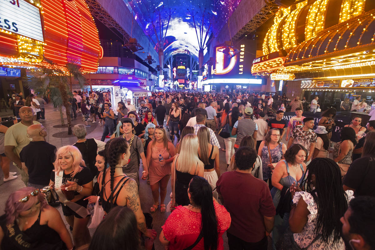 Visitors take in the sites at the Fremont Street Experience during Memorial Day weekend on Satu ...