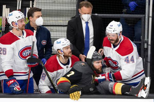 Golden Knights defenseman Alex Pietrangelo (7) falls into the Canadiens' bench while Canadiens ...