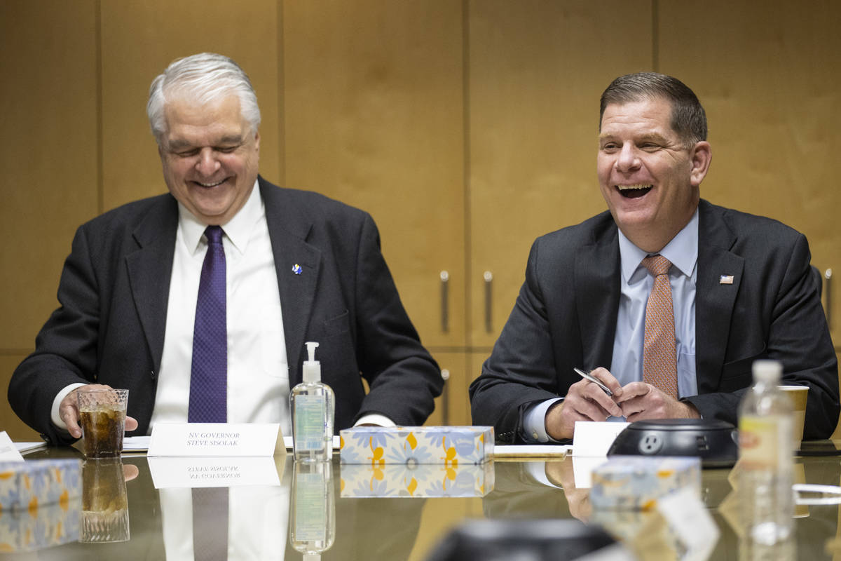 Nevada Gov. Steve Sisolak, left, and U.S. Labor Secretary Marty Walsh, participate during a rou ...