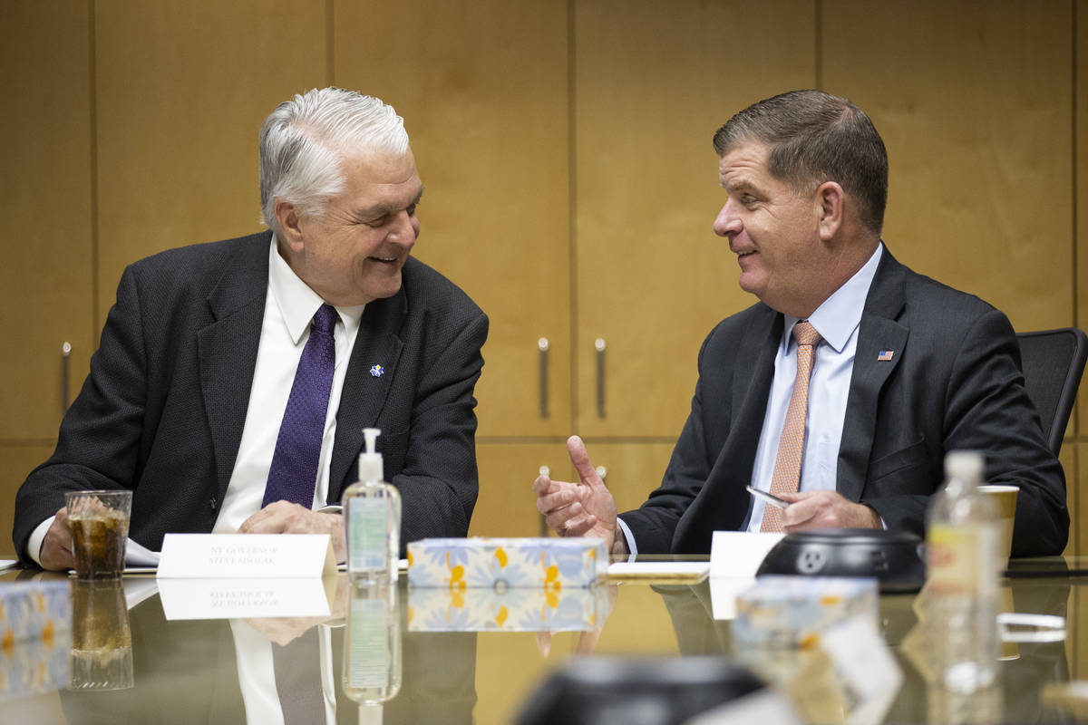 Nevada Gov. Steve Sisolak, left, and U.S. Labor Secretary Marty Walsh, participate during a rou ...