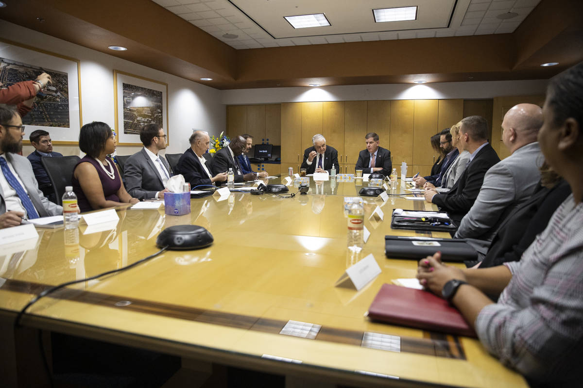 Nevada Gov. Steve Sisolak, left, and U.S. Labor Secretary Marty Walsh, participate during a rou ...