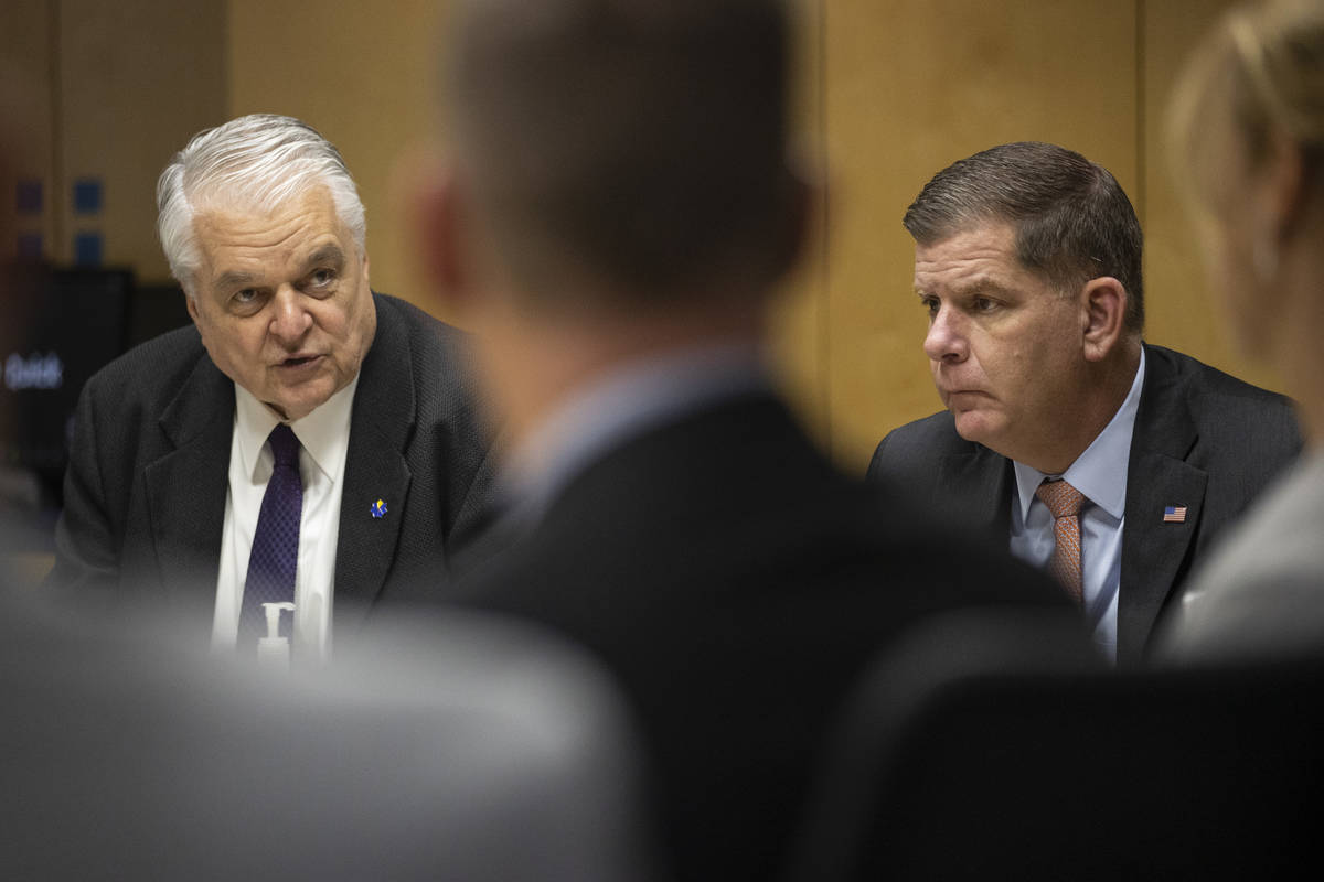 Nevada Gov. Steve Sisolak, left, and U.S. Labor Secretary Marty Walsh, participate during a rou ...