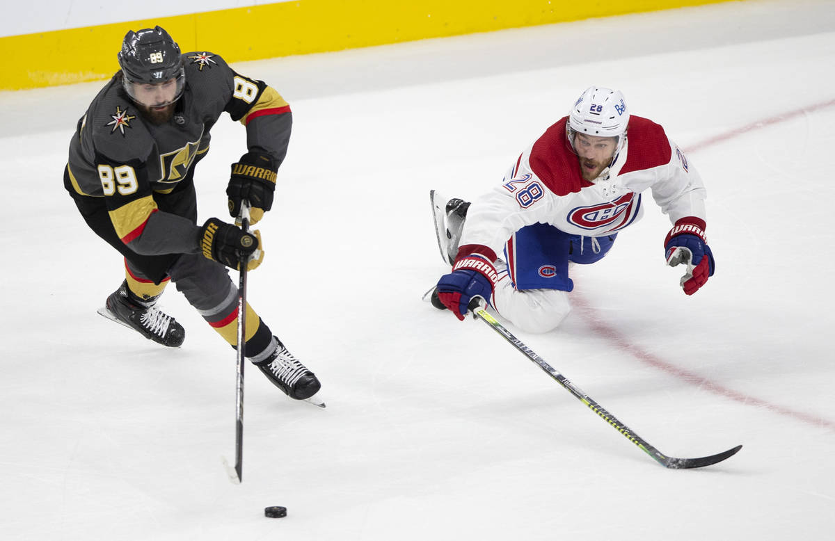 Golden Knights right wing Alex Tuch (89) and Canadiens defenseman Jon Merrill (28) skate for th ...