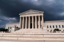 In this June 8, 2021 photo, with dark clouds overhead, the Supreme Court is seen in Washington. ...