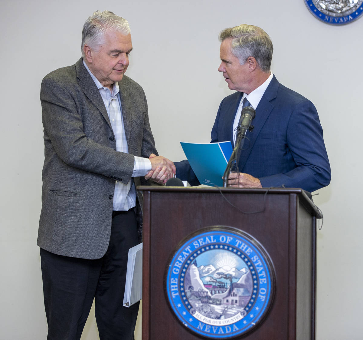 Gov. Steve Sisolak, left, shakes hands with the Nevada COVID-19 Response, Relief and Recovery T ...