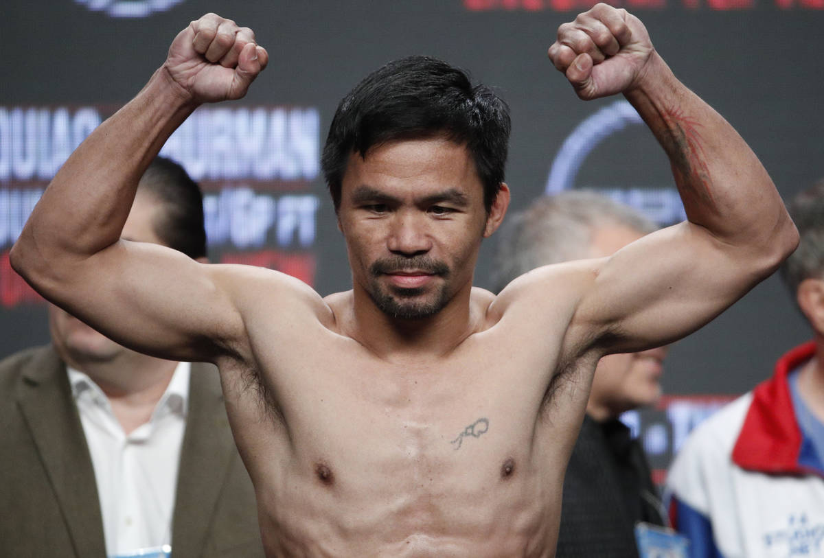 Manny Pacquiao poses on the scale during a weigh-in Friday, July 19, 2019, in Las Vegas. Pacqui ...