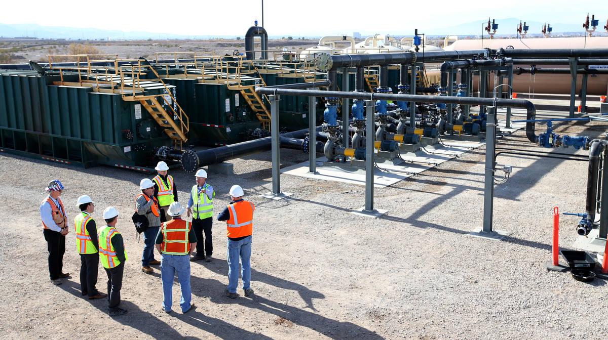 Dan Pastor, principal engineer with Tetra Tech, top right, gives a tour to dignitaries and memb ...