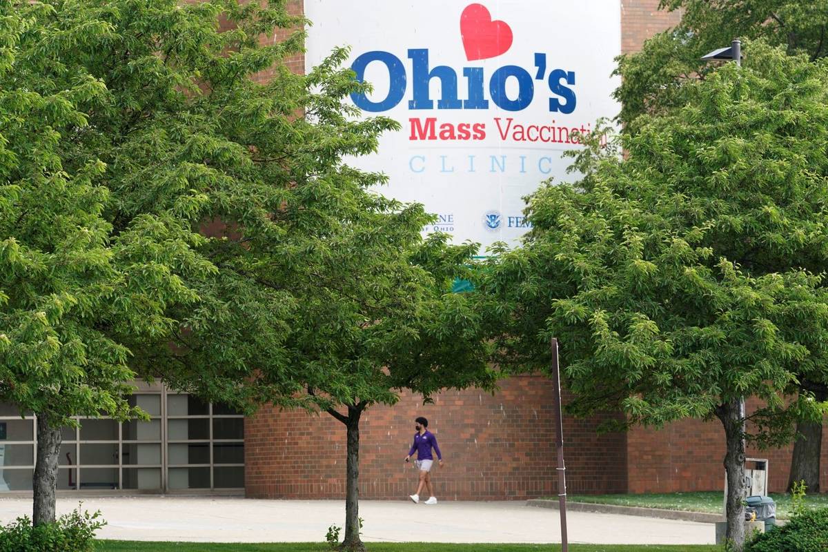 A man walks by the entrance for Ohio's COVID-19 mass vaccination clinic at Cleveland State Univ ...