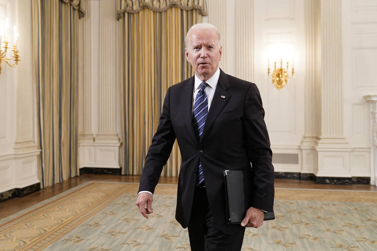 President Joe Biden walks out of the State Dining room after an event with Attorney General Mer ...