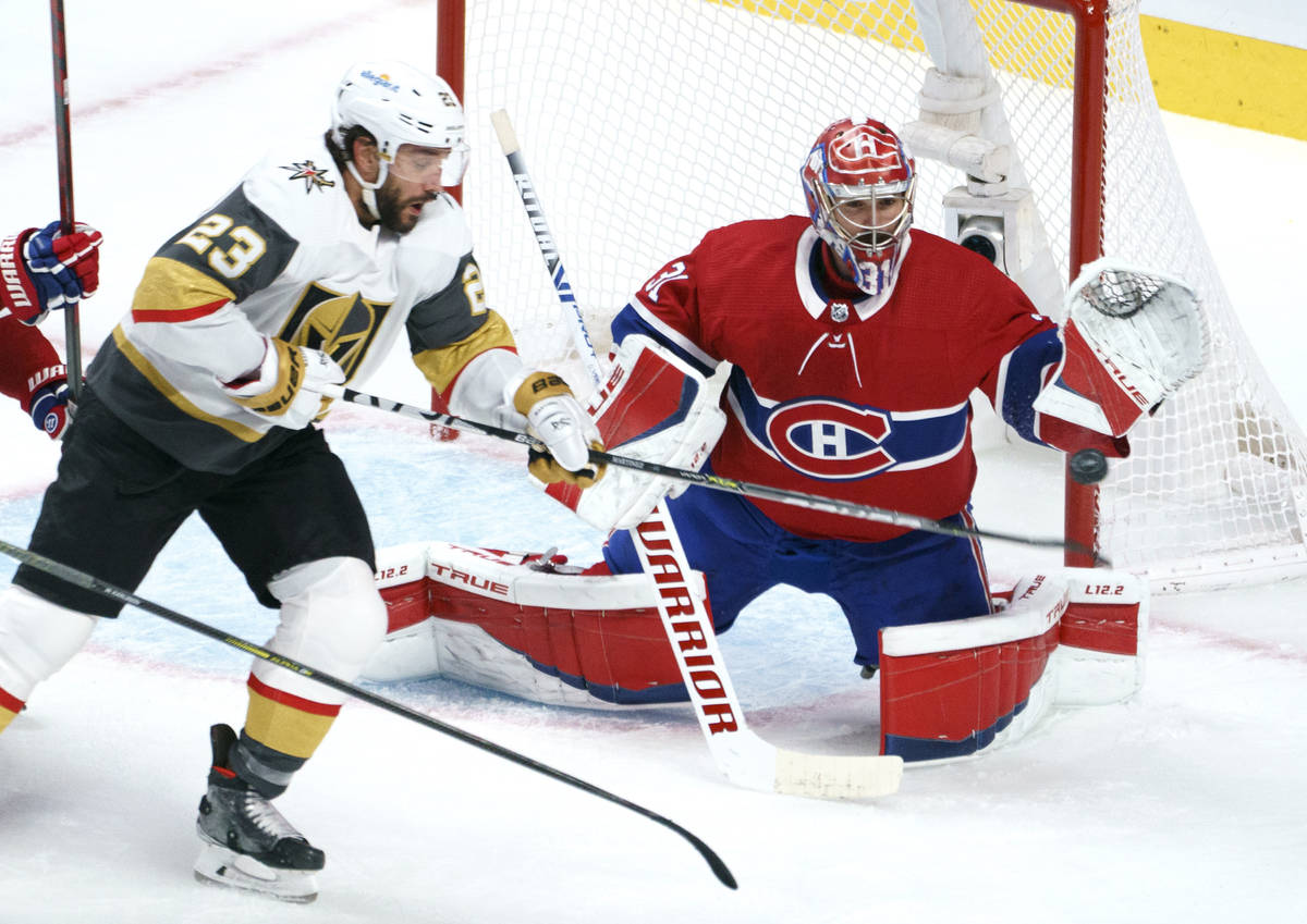 Vegas Golden Knights' Alec Martinez (23) tries to deflect a shot past Montreal Canadiens goalte ...