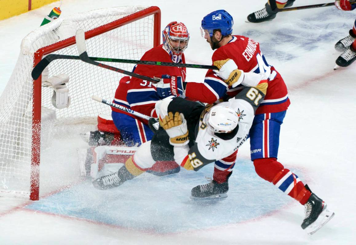 Vegas Golden Knights' Reilly Smith (19) is taken out by Montreal Canadiens defenseman Joel Edmu ...