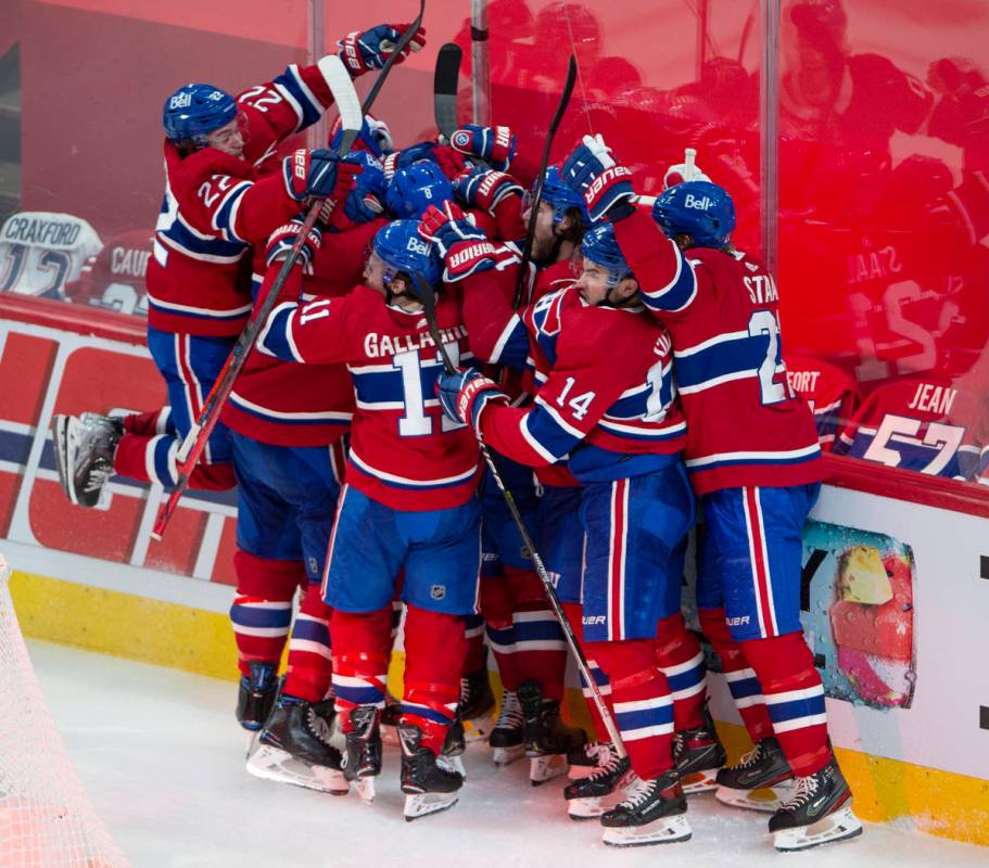 Montreal Canadiens players celebrate after defeating the Vegas Golden Knights following overtim ...