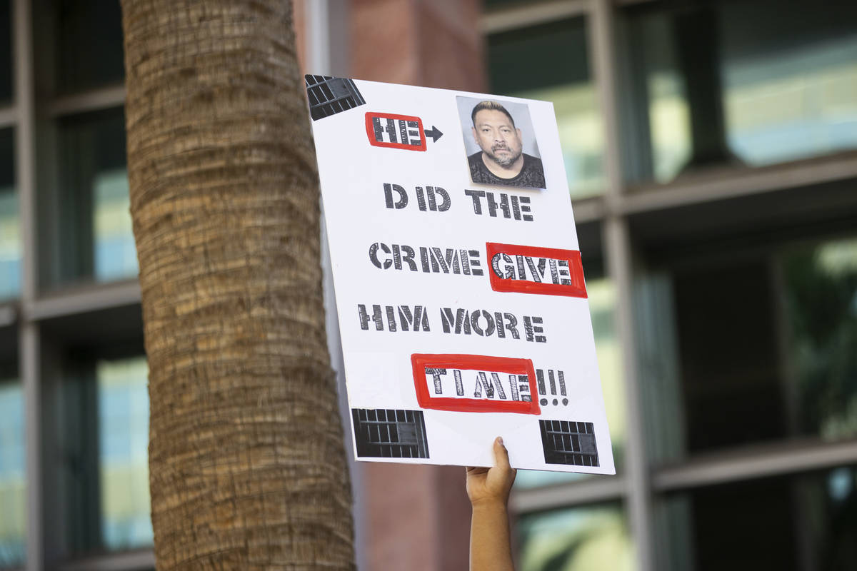 A person holds up a sign in a protest to call for justice in the Lesly Palacio murder case, at ...