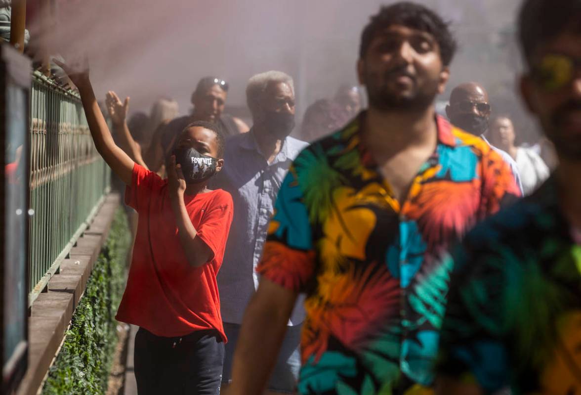 Keith Batiste, 10, of California and others cool off in the misters outside the Paris Las Vegas ...