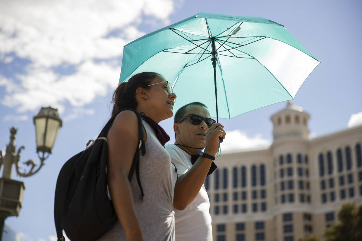 Amparo Solano, left, and her boyfriend German Zuluaga of Colombia, walk the Strip near the Bell ...