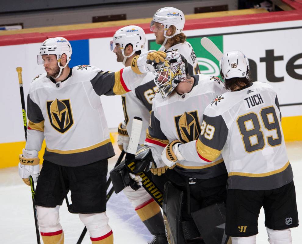 Vegas Golden Knights goaltender Robin Lehner (90) is consoled by teammates after giving up the ...