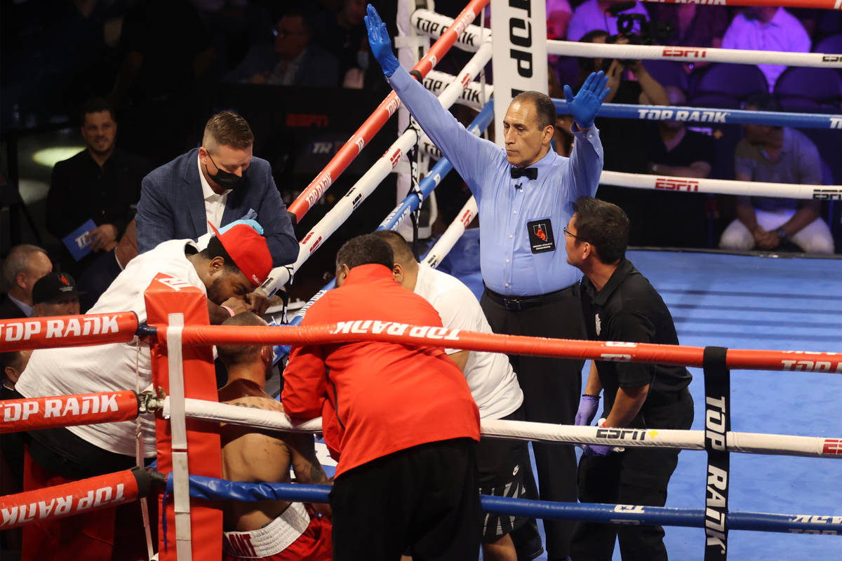 The referee signals the end of the fight at the end of the eight round after the team of Rob Br ...