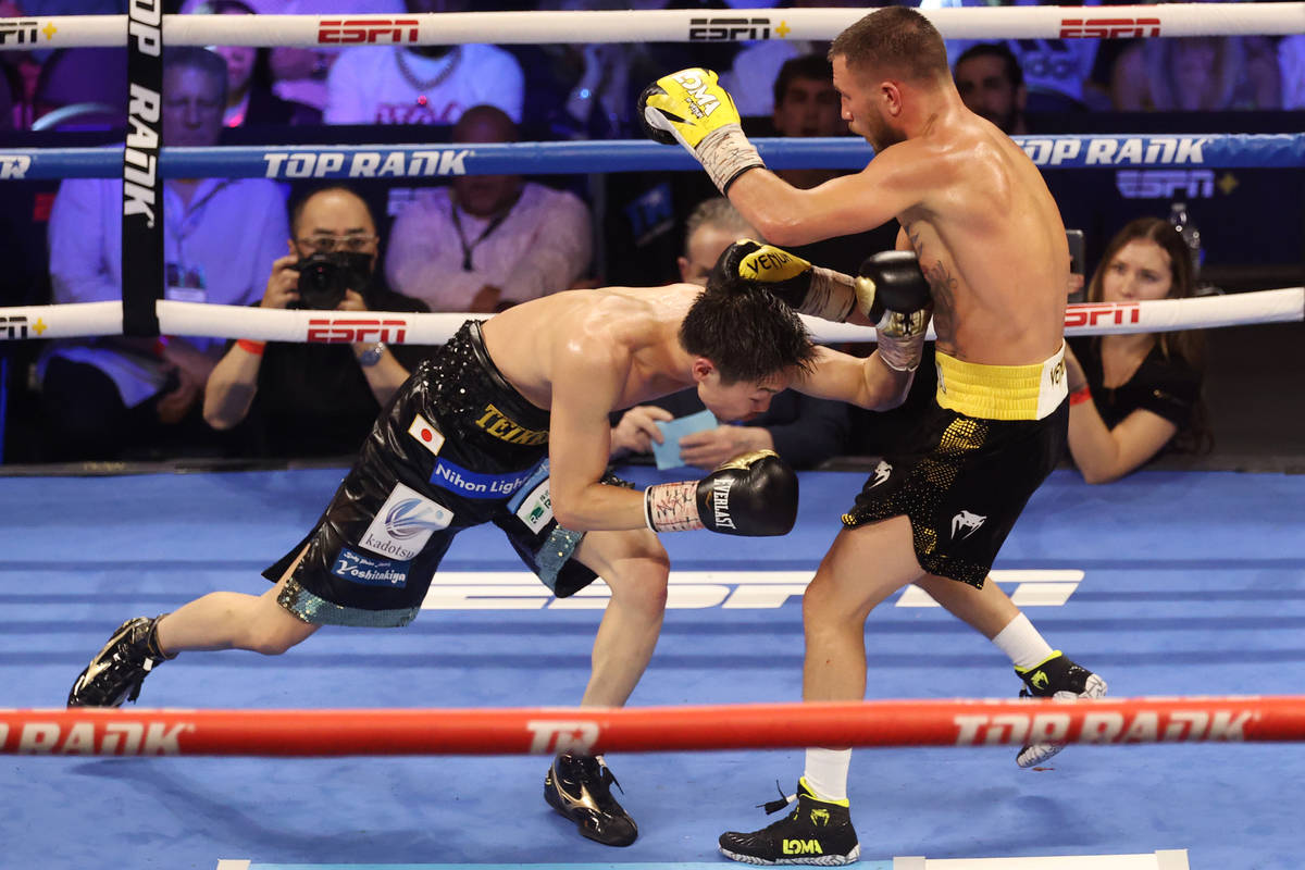 Masayoshi Nakatani, left, battles Vasyl Lomachenko in the ninth round of the lightweight bout a ...