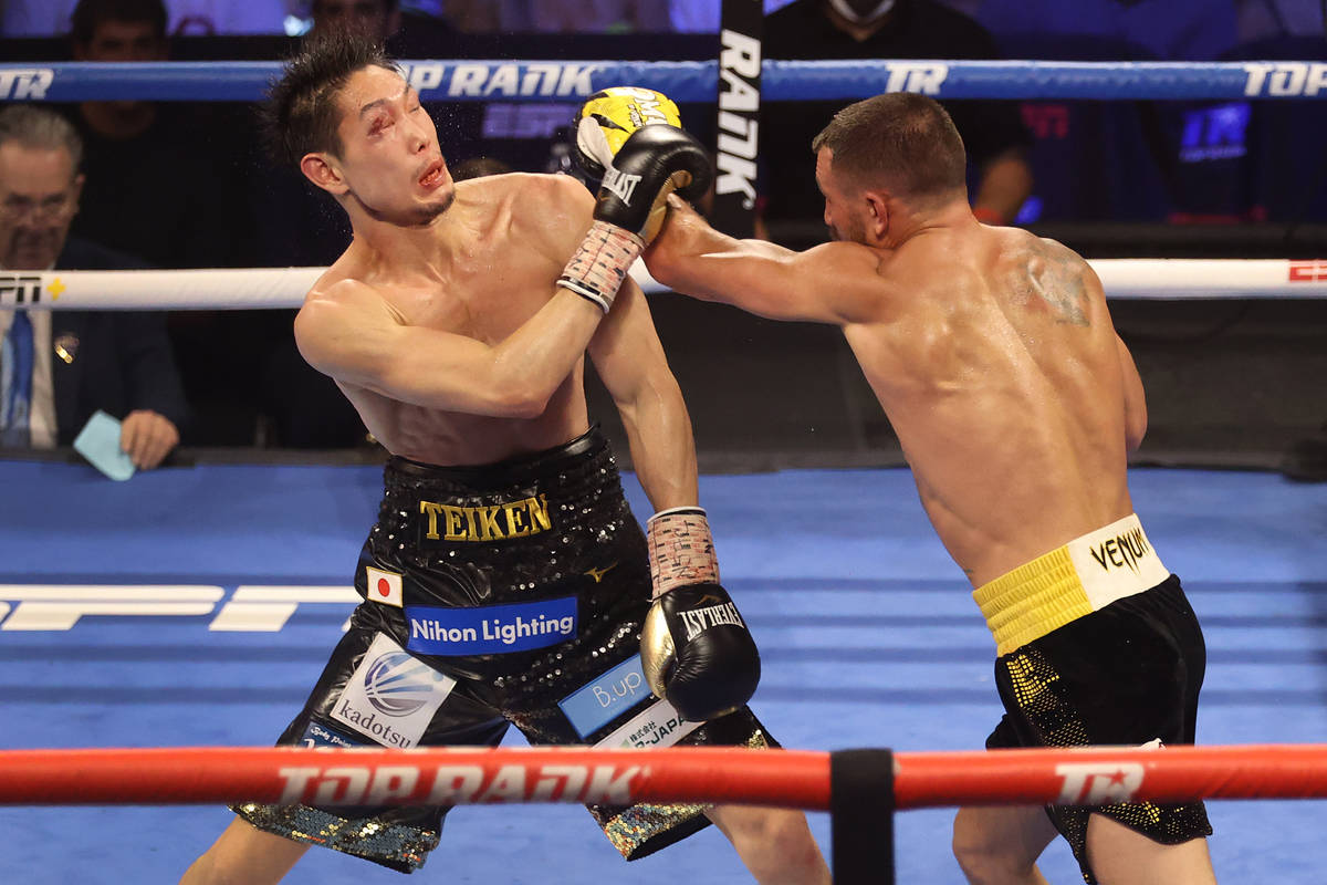 Vasyl Lomachenko, right, connects a punch against Masayoshi Nakatani in the seventh round of th ...