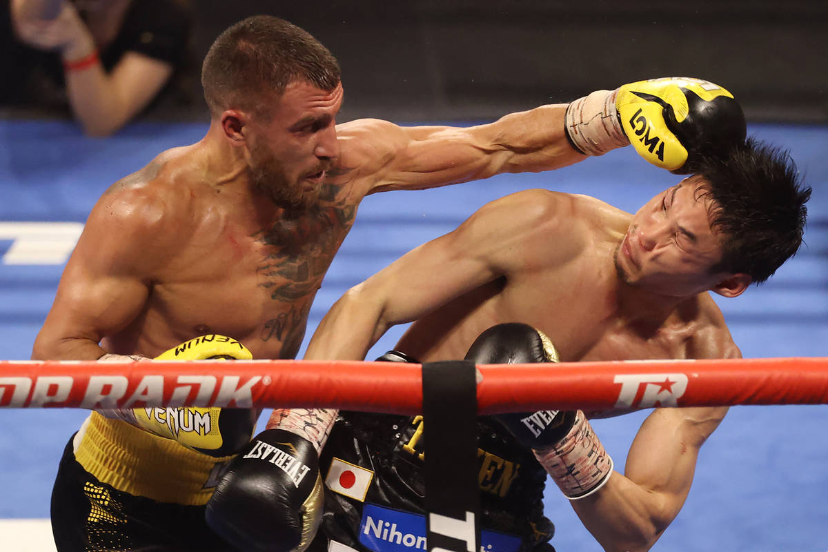 Vasyl Lomachenko, left, connects a punch against Masayoshi Nakatani in the fifth round of the l ...