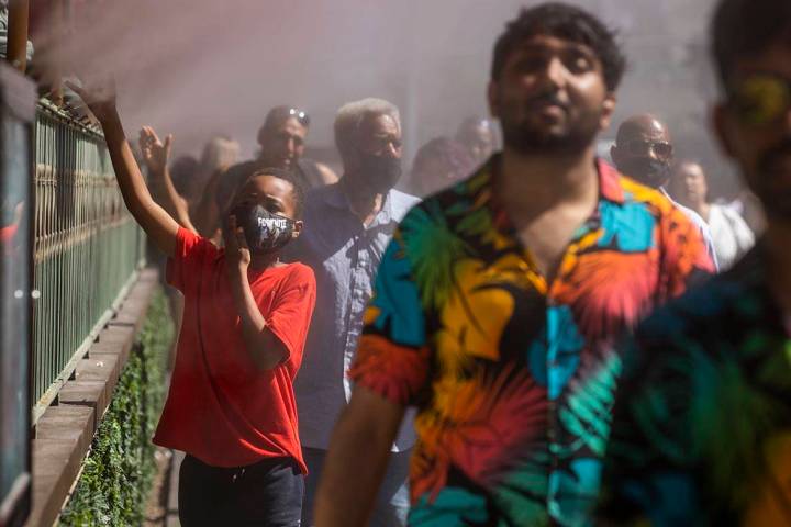 Keith Batiste, 10, of California and others cool off in misters outside the Paris Las Vegas as ...