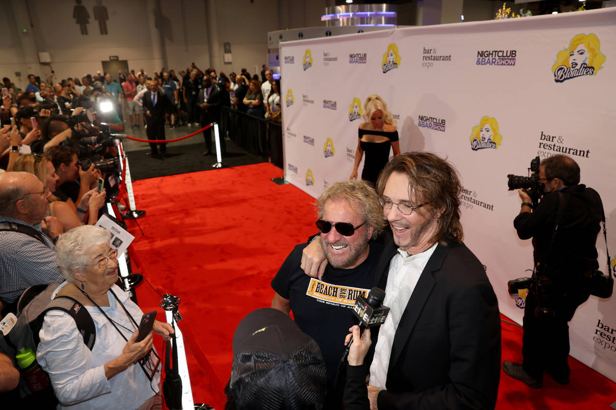 Sammy Hagar, left, and Rick Springfield walk the red carpet as Jenny McCarthy, rear, poses for ...