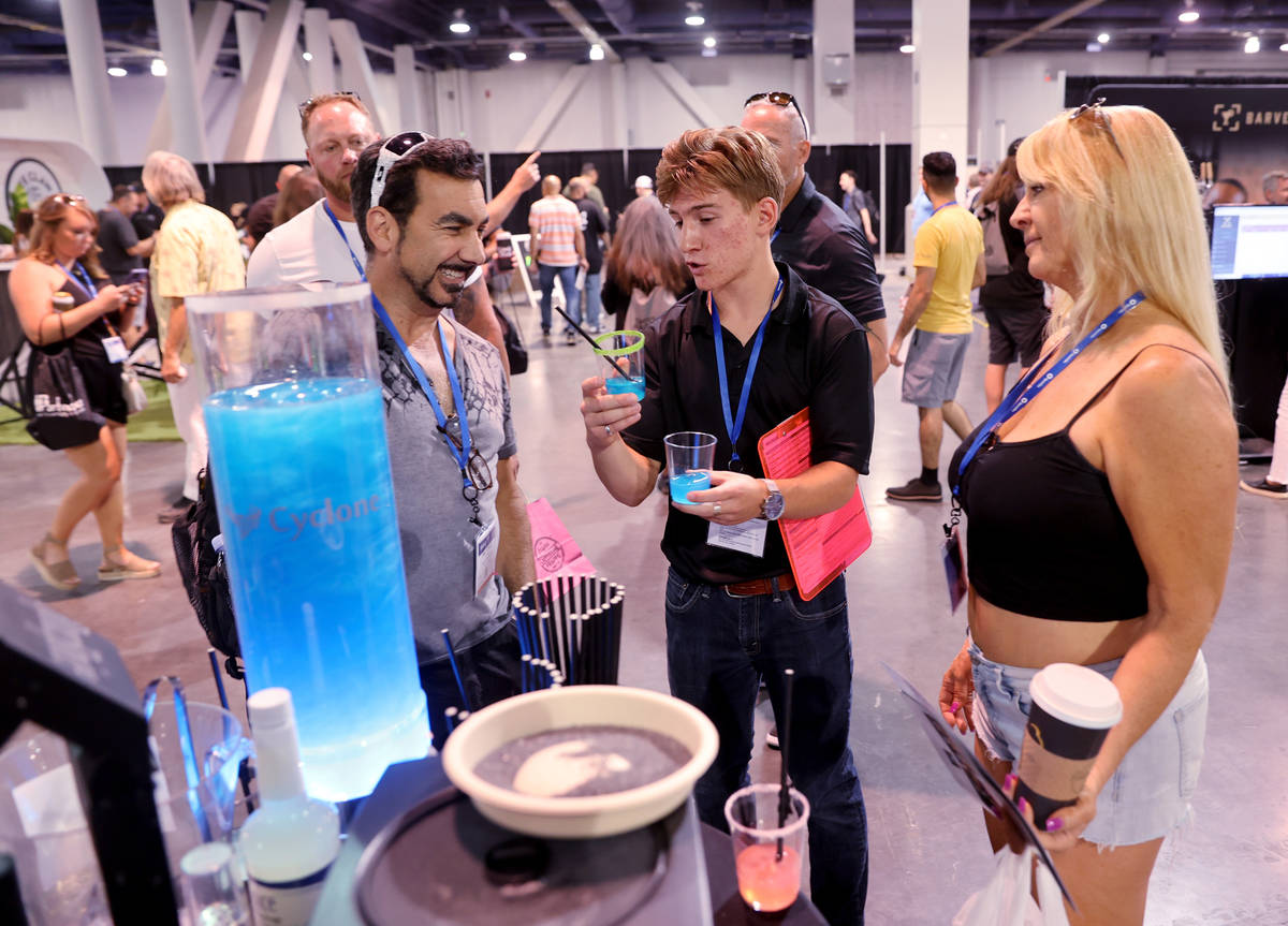 Jacob Radow of Reno, center, offers drink samples to Sal Vitalie and Laura Godby of South San F ...