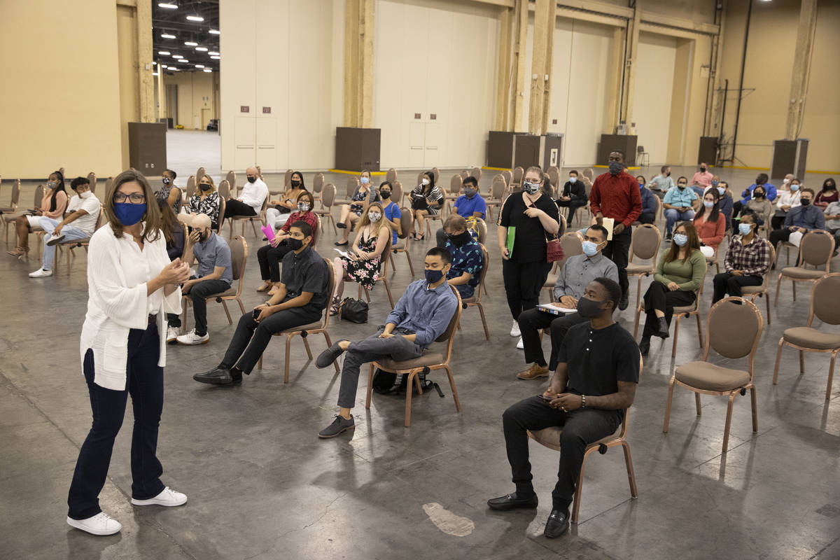 Job seekers wait to be called for an interview during a job fair at the Mandalay Bay Convention ...