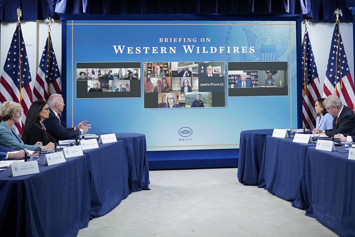 President Joe Biden, third from left, speaks during an event in the South Court Auditorium on t ...