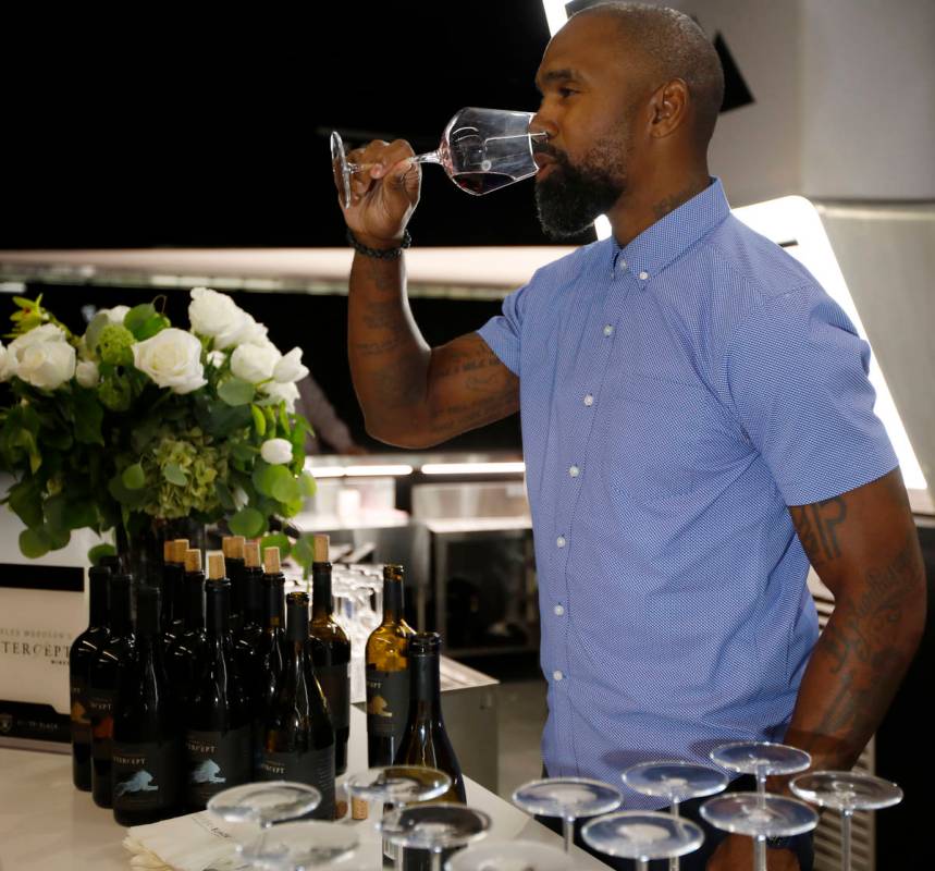 Former NFL football player Charles Woodson drinks a glass of wine while promoting his "Int ...
