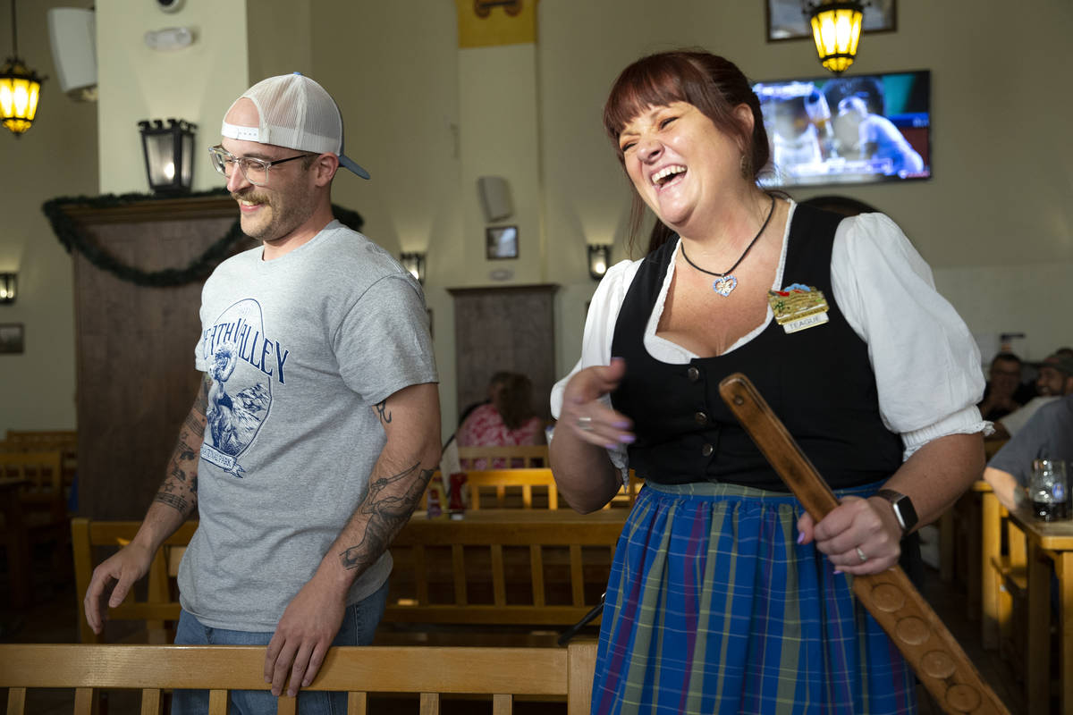 Adam Ross, of Illinois, left, laughs after server Teague Katz gave him a birthday spanking at H ...