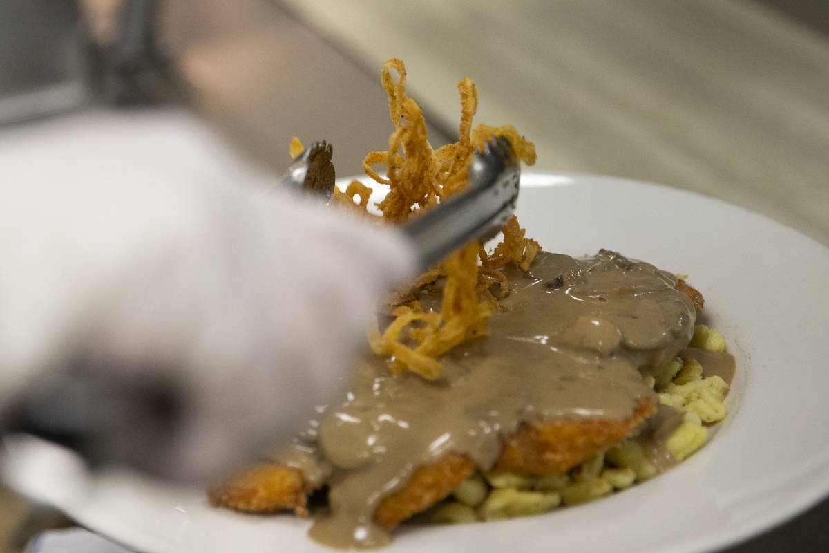 The "Gegrillte Hhnchenbrust," chicken in mushroom sauce, is topped with fried onions ...