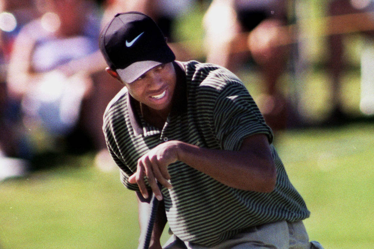 Tiger Woods defeated Davis Love III on the first hole of a sudden death playoff to notch the fi ...