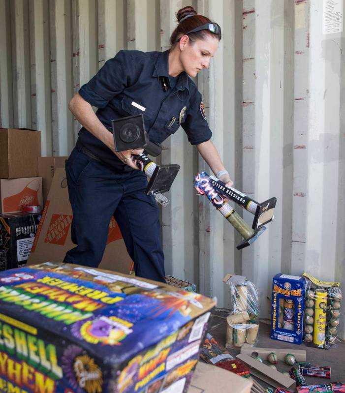 Amanda Wildermuth, with Clark County Fire Prevention, organizes confiscated illegal fireworks t ...