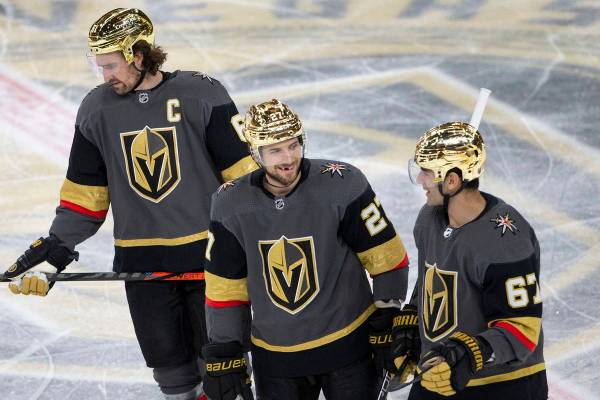 Golden Knights defenseman Shea Theodore (27) communicates with Golden Knights right wing Mark S ...