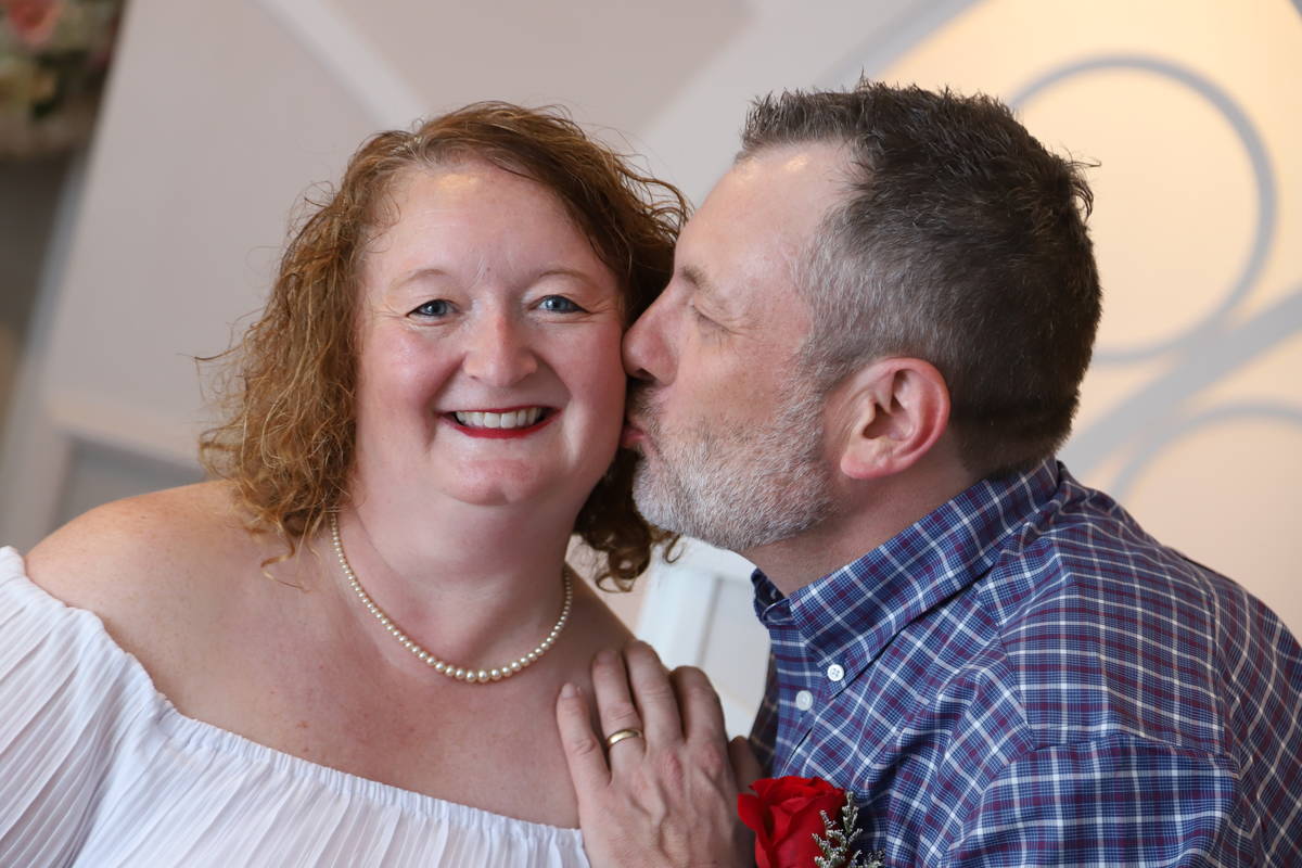 Don Couse gives his wife, Cindy, a kiss on the cheek after the couple renewed their vows at Gra ...