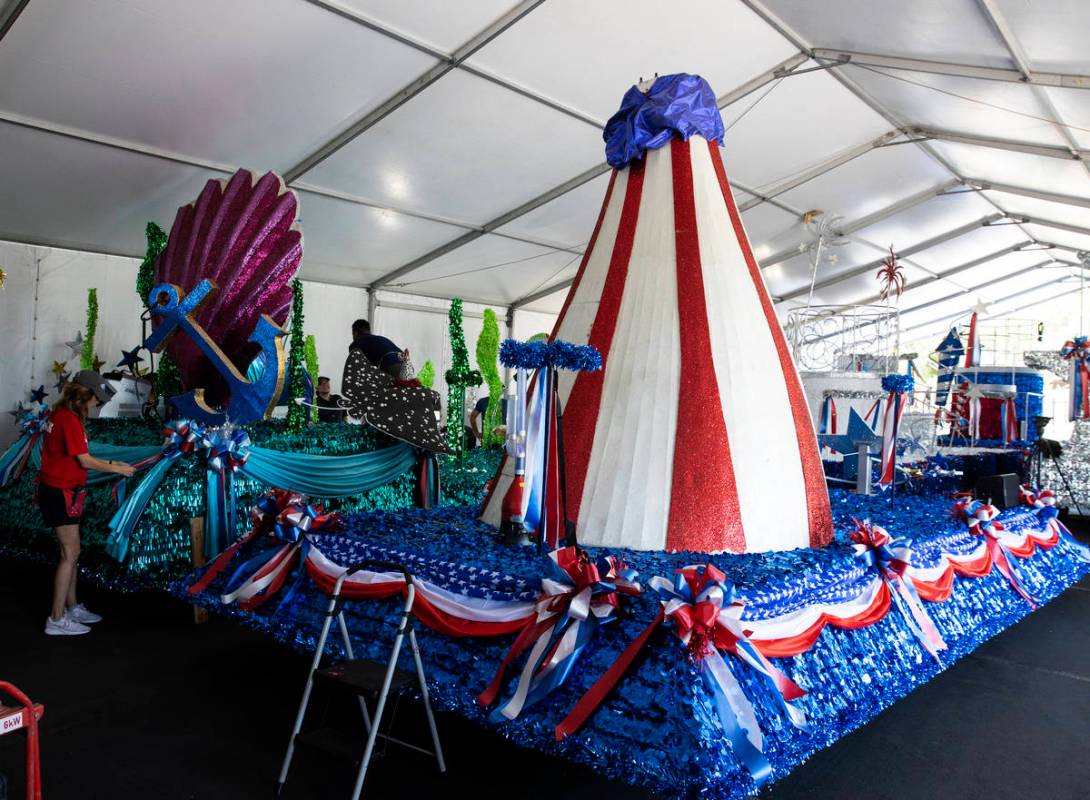 Elizabeth Engle, a volunteer, decorates "Undersea Jubilee" float for the July 4th Summerlin Cou ...