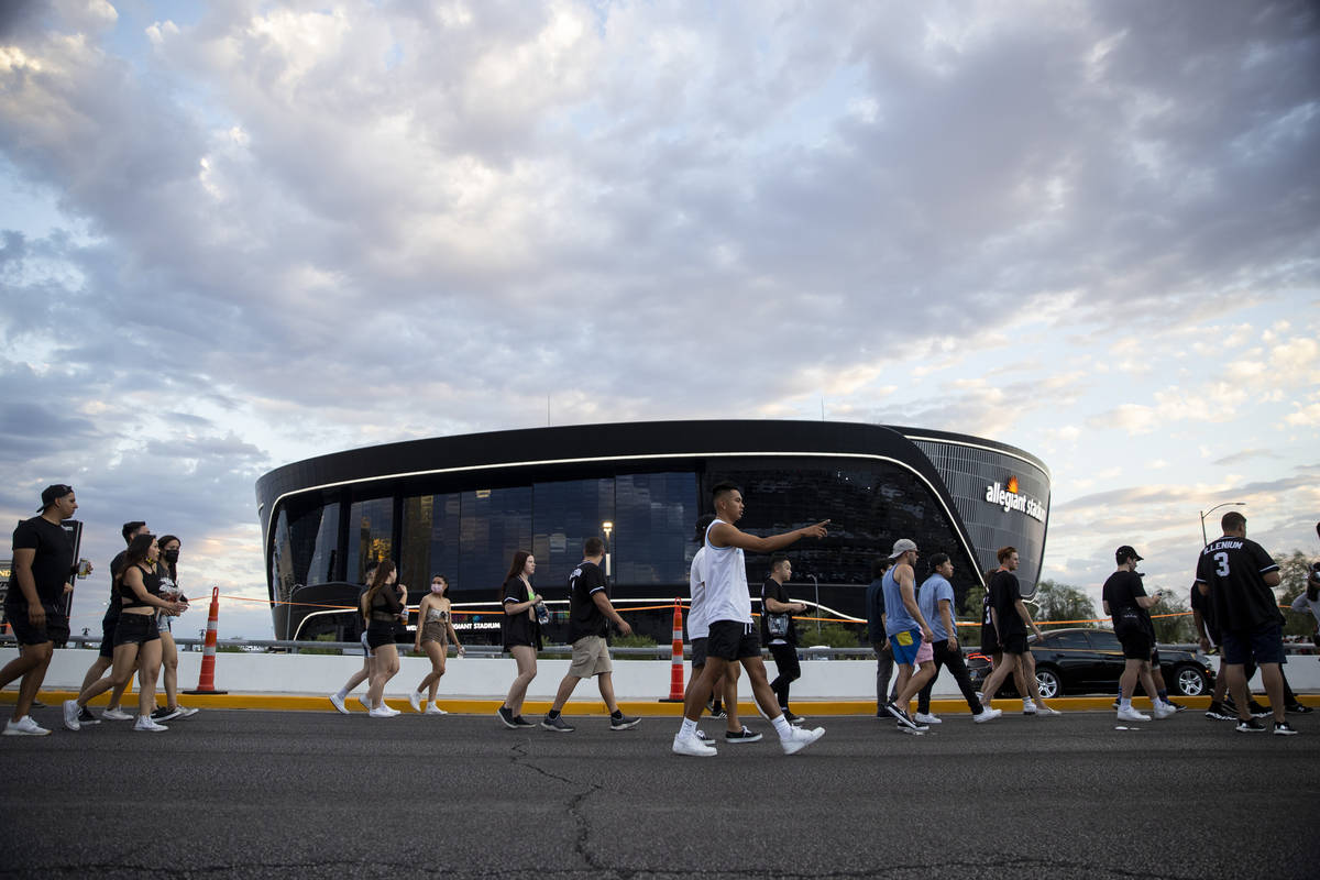 People line up on the Hacienda Avenue bridge to enter Allegiant Stadium in Las Vegas for the Il ...