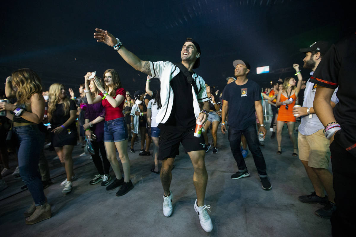 People watch Illenium perform at Allegiant Stadium in Las Vegas, Saturday, July 3, 2021. (Erik ...