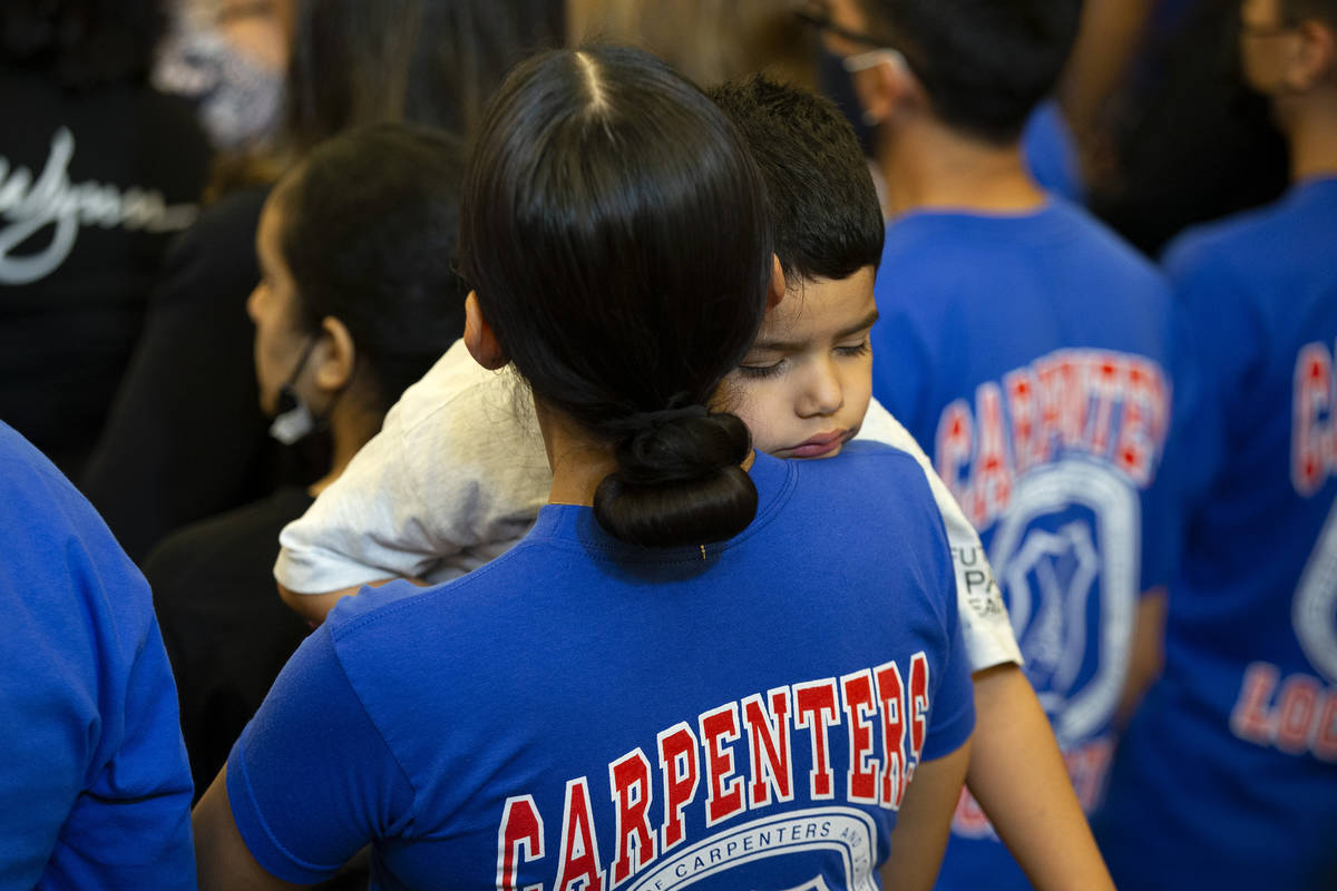 A boy sleeps while Vice President Kamala Harris speaks to members of the United Brotherhood of ...