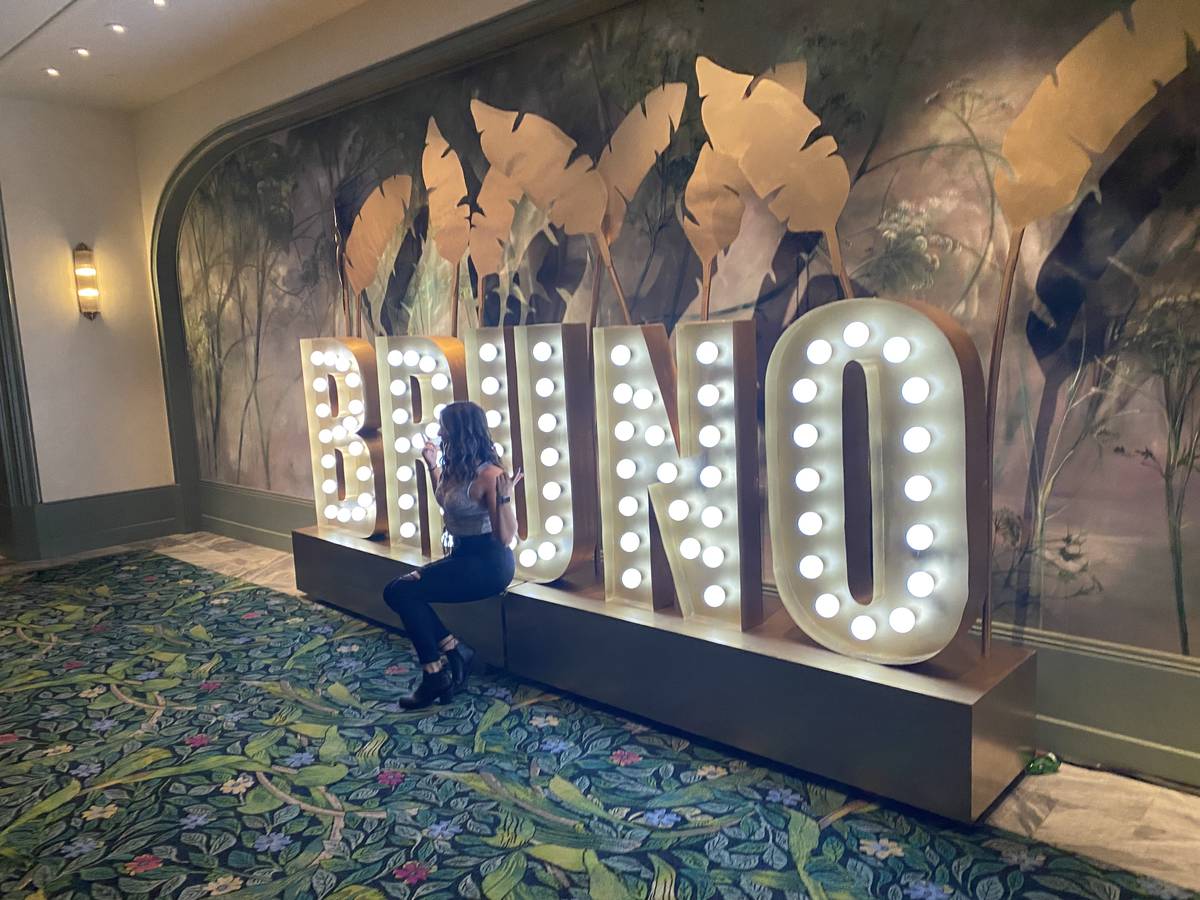 A fan poses at the new BRUNO sign in the walkway to the casino floor at Park Theater at Park MG ...