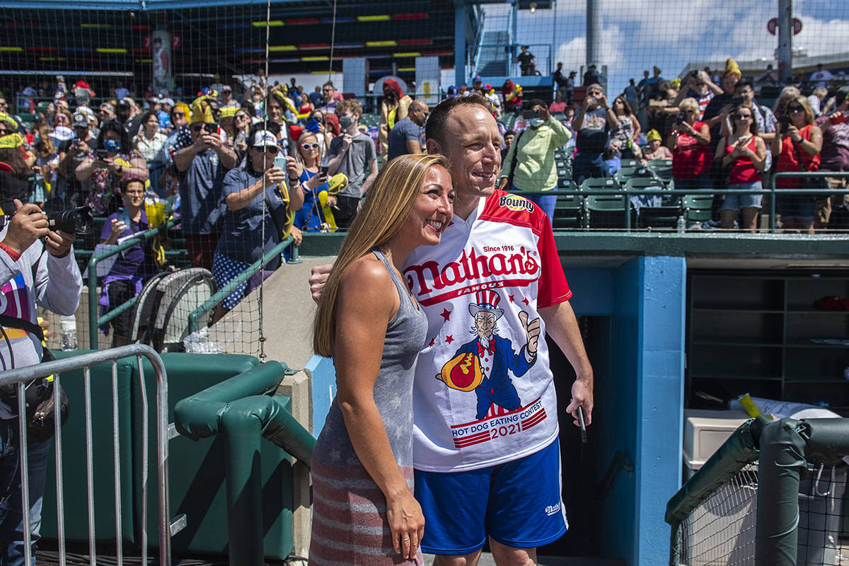 Danielle Diaz, left, takes a photo with Joey Chestnut at the Nathan's Famous Fourth of July Int ...