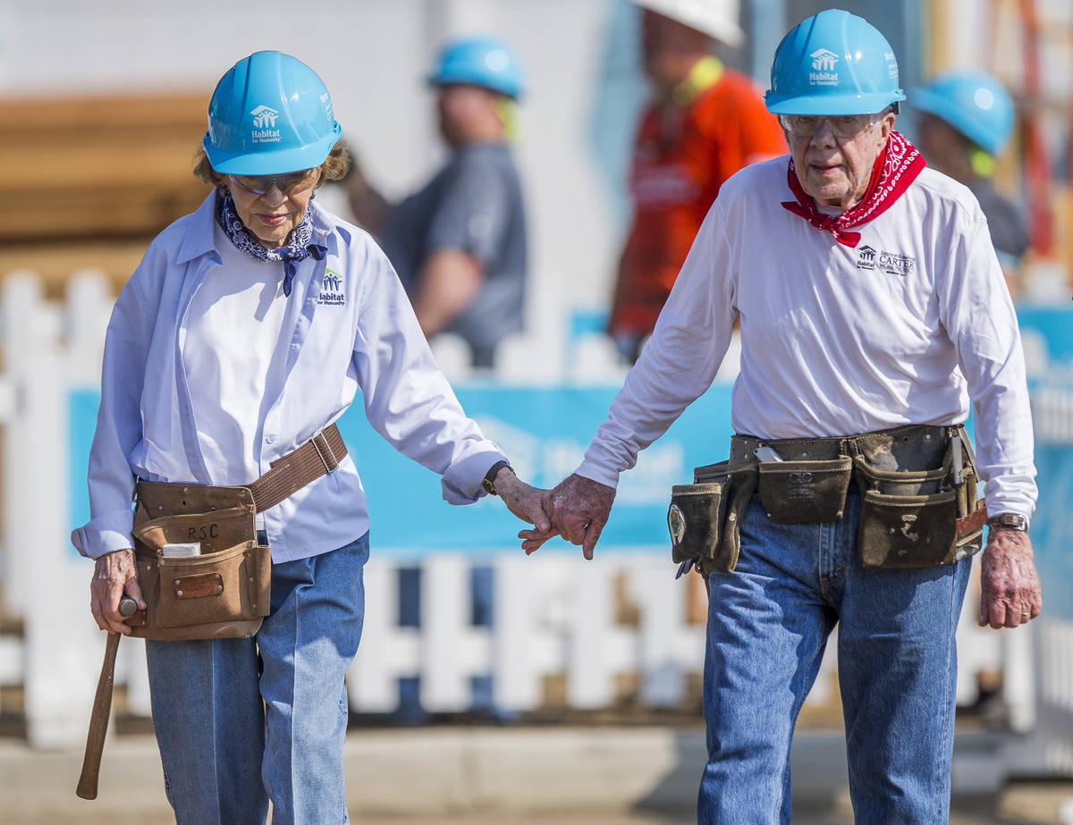 FILE - In this Aug. 27, 2018 file photo former President Jimmy Carter holds hands with his wife ...