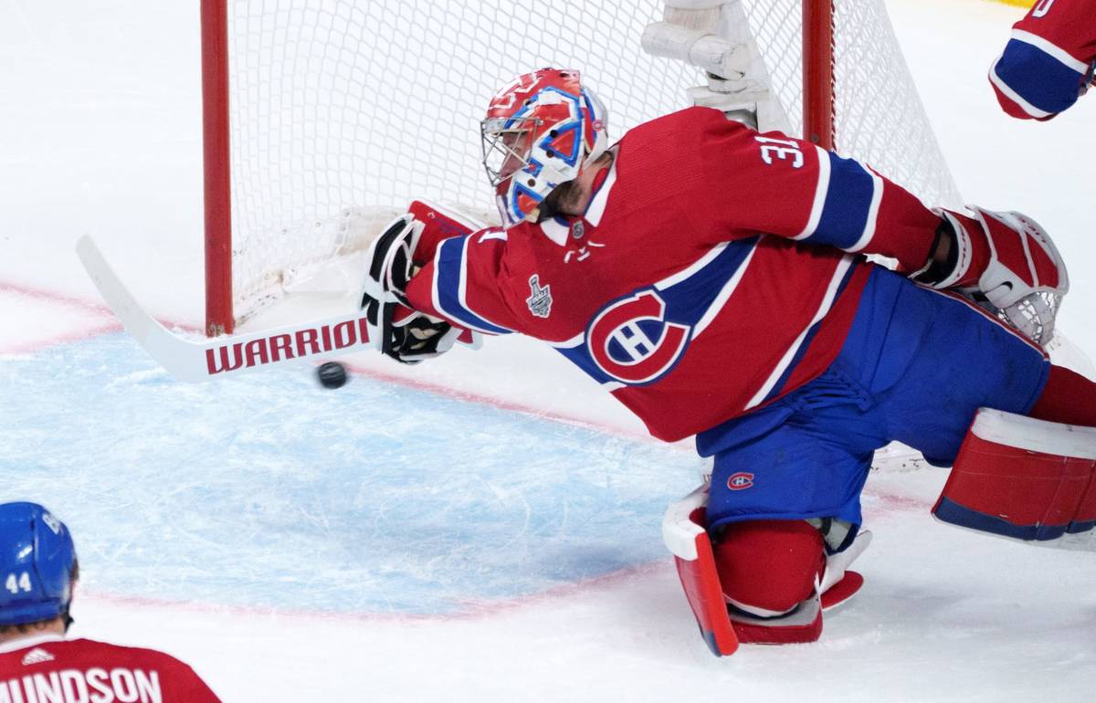 The puck goes into the net underneath the stick of Montreal Canadiens goaltender Carey Price on ...