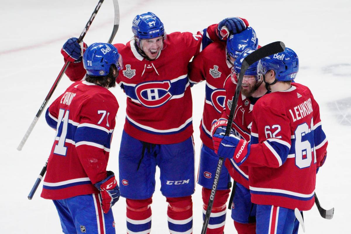 Montreal Canadiens defenseman Alexander Romanov (27) celebrates his goal with teammates Jake Ev ...