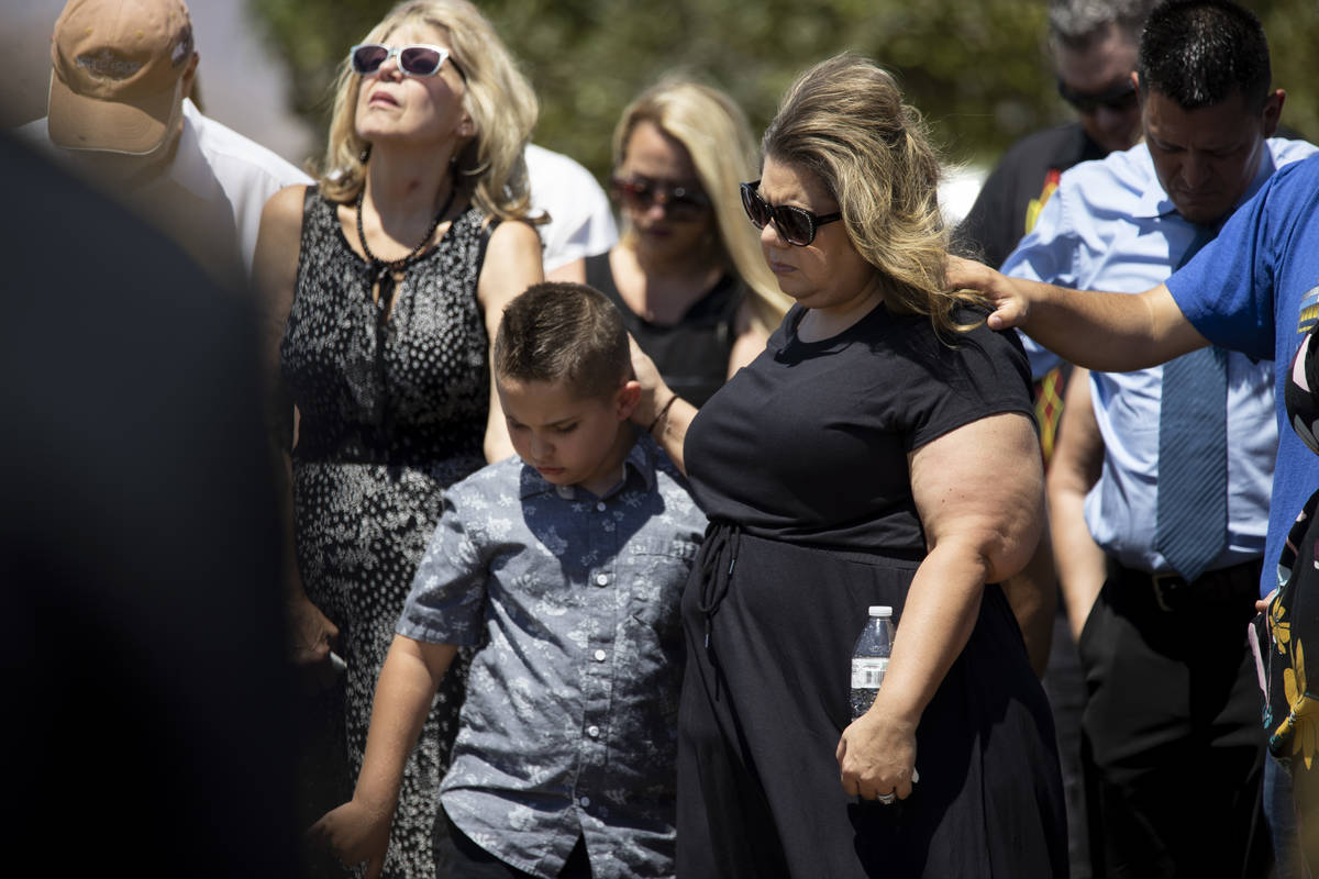 Christa Swanger, right, and her son Noah, 8, attend the funeral service for her husband, retire ...